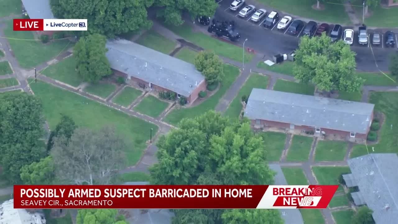 Possibly armed suspect barricaded in home