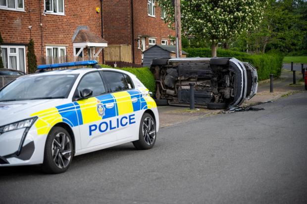 Two teens arrested after car overturns in smash with police car in ...