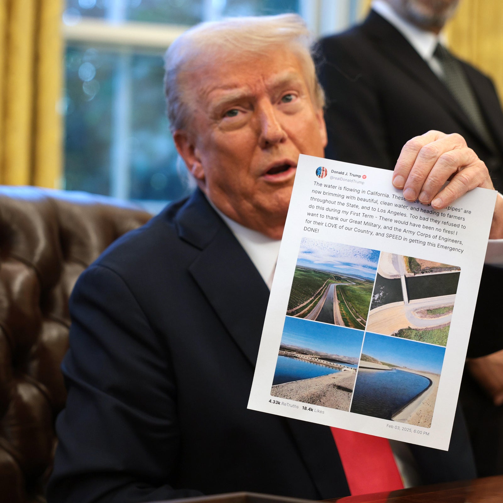 President Donald Trump holds up a paper copy of his social media post about the water supply in California as he signs an executive order in the Oval Office at the White House on February 25, 2025, in Washington, D.C.