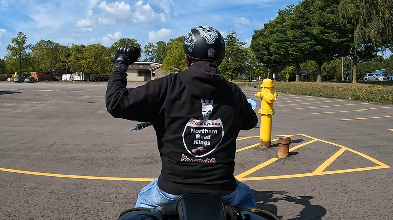 What Does It Mean When A Biker Raises Their Left Fist At 90-Degrees?