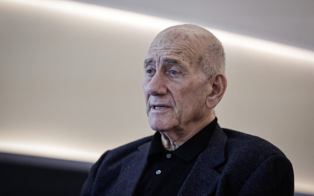 Police arrest man for spitting at ex-PM Olmert in Tel Aviv