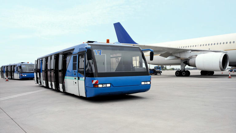 Why do passengers sometimes have to take a bus to the plane?