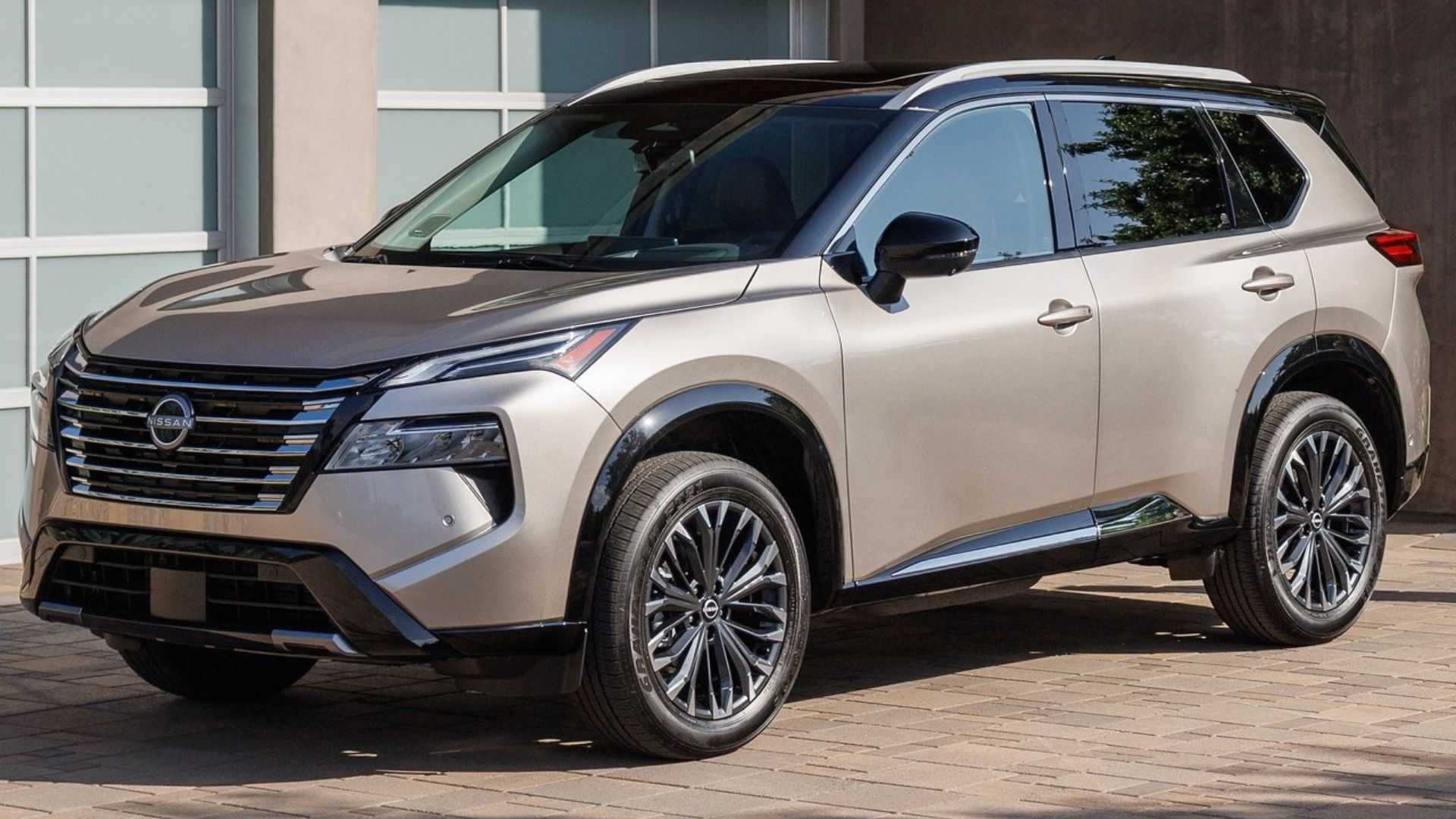 Static front 3/4 shot of a gold 2024 Nissan Rogue.