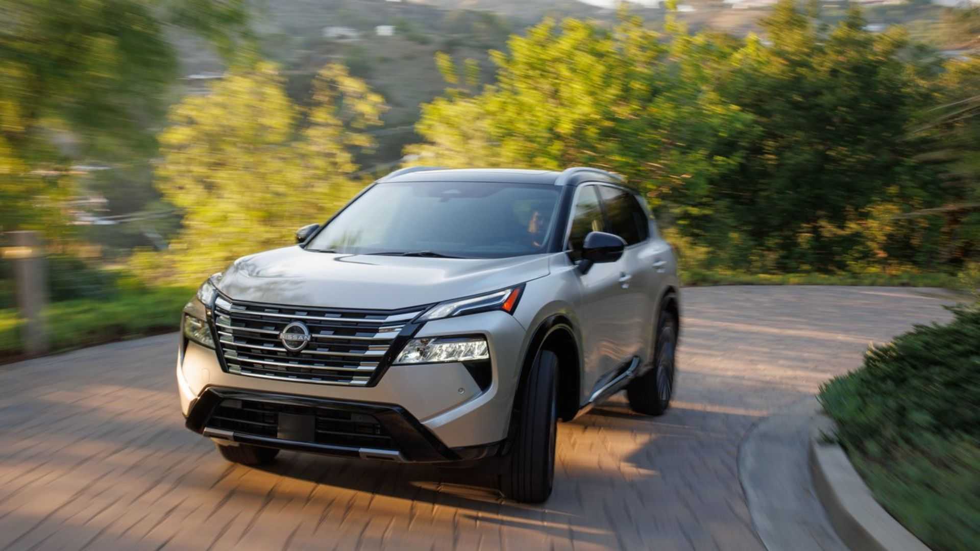 Dynamic front-end shot of a gold 2024 Nissan Rogue.