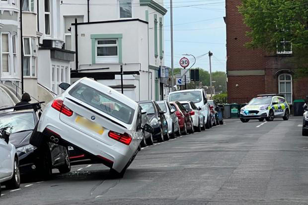 Driver arrested after crashing into parked cars
