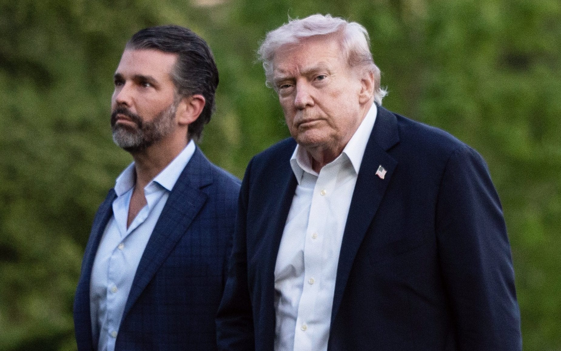 President Donald Trump, with son Donald Trump Jr., walks across the South Lawn upon returning to the White House from Florida on May 3, 2026 in Washington, DC