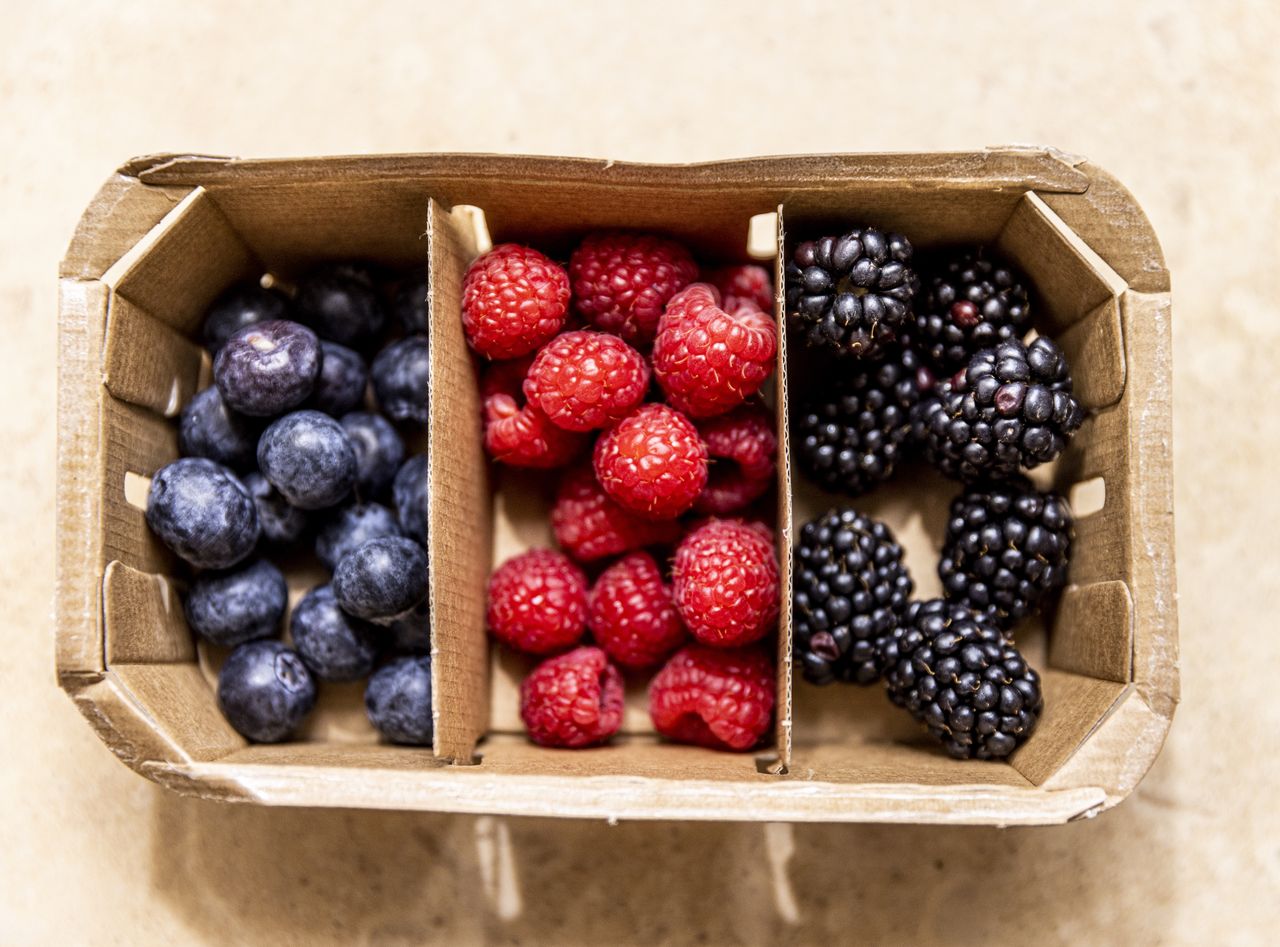 Wooden basket with sections for blueberries raspberries and blackberries