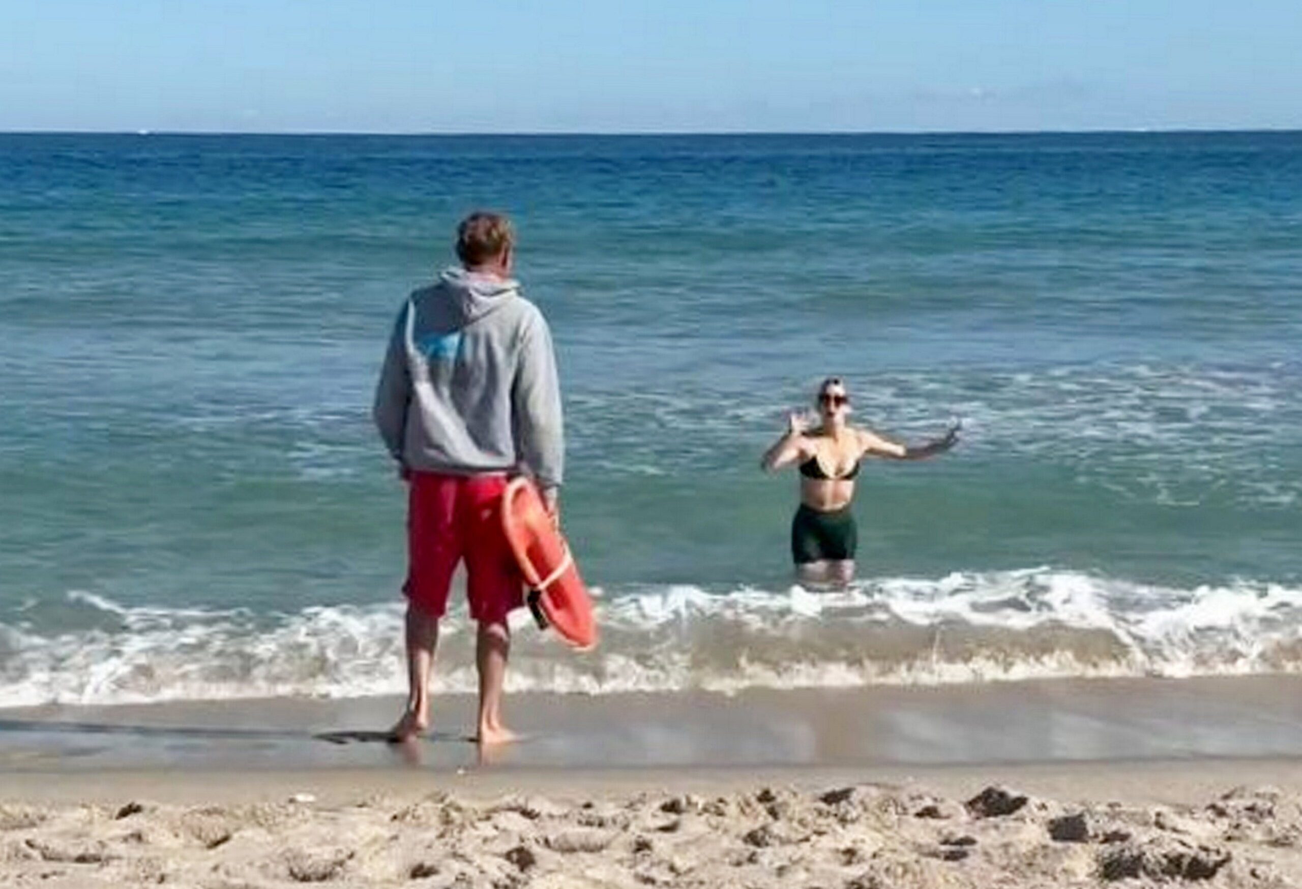 Shark appears seconds after lifeguard tells swimmer to get out of water
