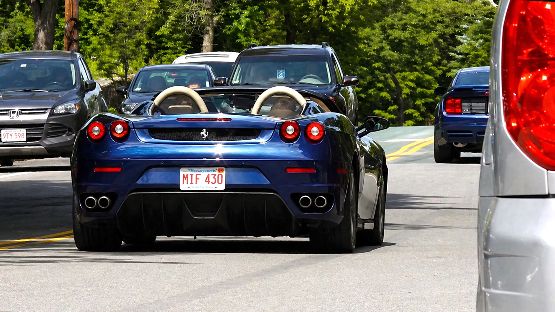 Ferrari accelerates with loud engine sound leaving car meet
