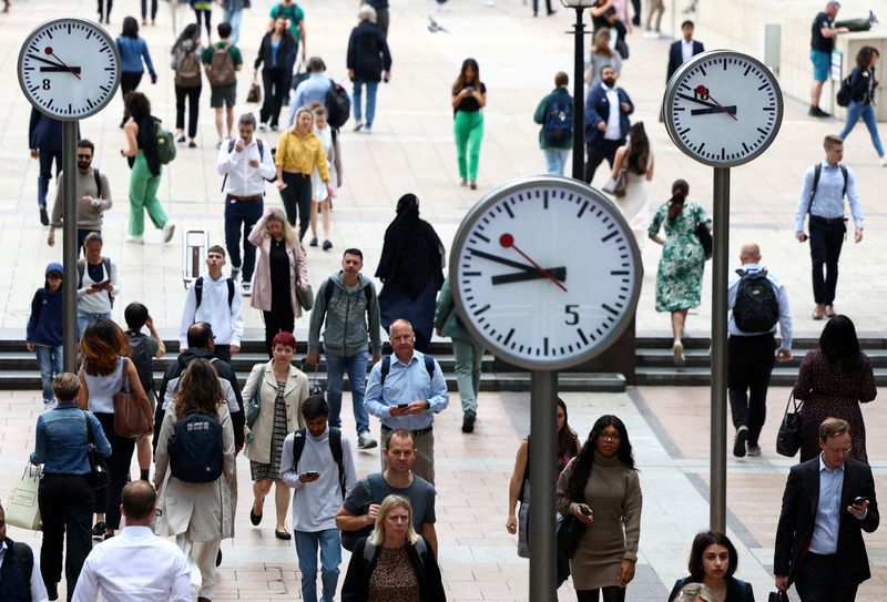 FILE PHOTO: Workers in Canary Wharf financial district of London