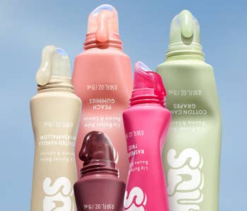 Five tubes of flavored lip balm with curved applicators, including toasted vanilla marshmallow, peach gummies, cotton candy grapes, and others