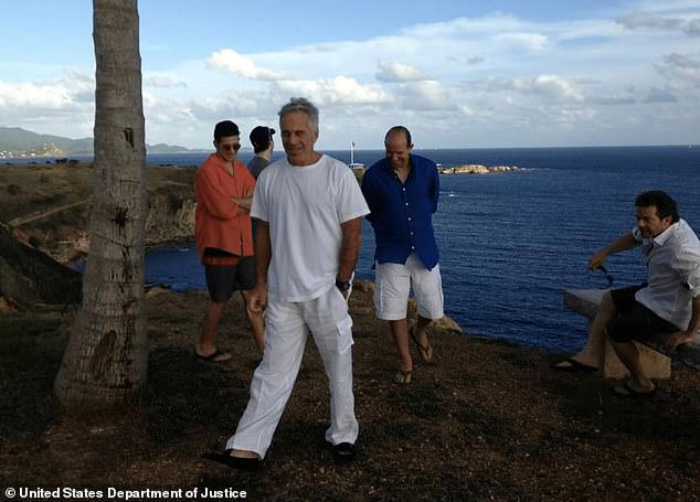 An image from the Epstein files shows Howard Lutnick (in blue) with along with Jeffrey Epstein