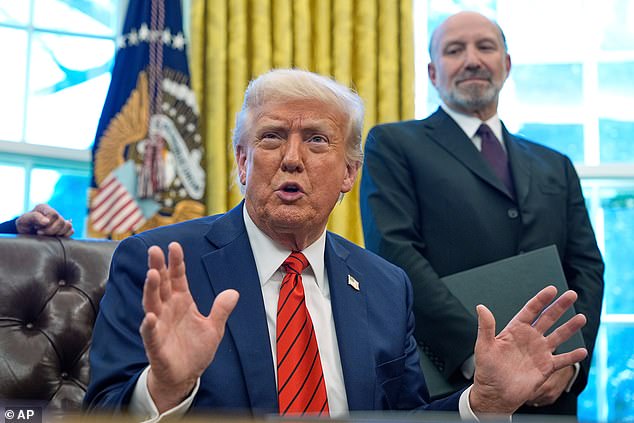 President Donald Trump speaks as he signs executive orders in the Oval Office of the White House, April 17, 2025, in Washington, as Commerce Secretary Howard Lutnick listens