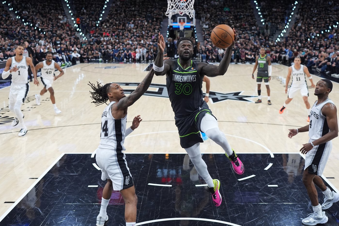 Minnesota Timberwolves forward Julius Randle (30) drives to the basket against San Antonio Spurs guard Devin Vassell (24) during the first half in Game 2 of a second-round NBA playoffs basketball series in San Antonio, Wednesday, May 6, 2026. (AP Photo/Eric Gay)