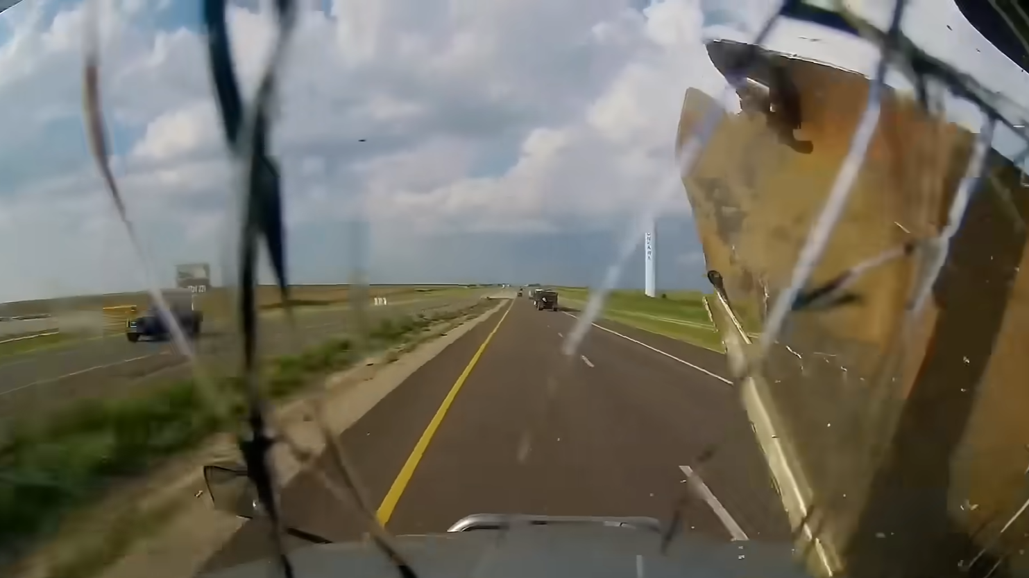 Flying shrapnel empales truck windshield - lands centimeters away from ...