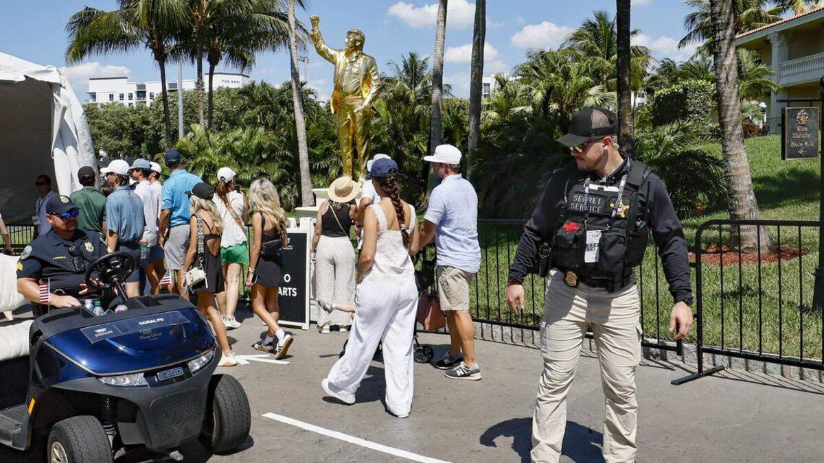 Attendees approach a security entrance in front of President Donald Trump's new golden statue during round three of the 2026 Cadillac Championship at Trump National Doral in Doral, Florida, on May 2 ©Photograph by Al Diaz