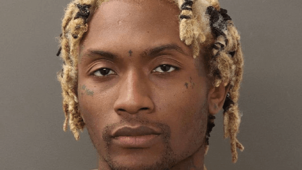 Man charged with murder after body found wrapped in rug outside of home