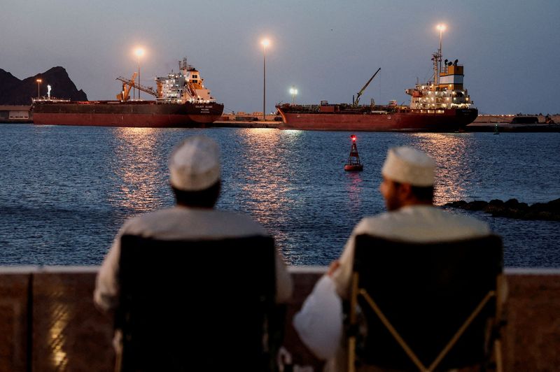 FILE PHOTO: Galaxy Globe bulk carrier and Luojiashan tanker sit anchored in Muscat