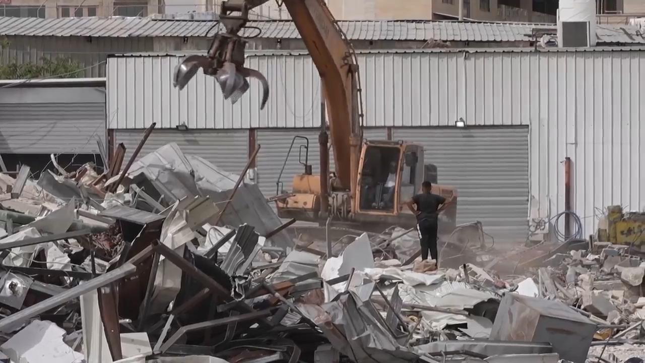 Israeli bulldozers demolish Palestinian shops on edge of town southeast ...