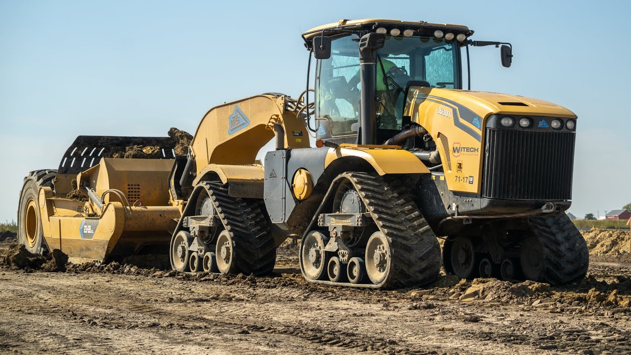 Large scraper equipment moving soil across jobsite
