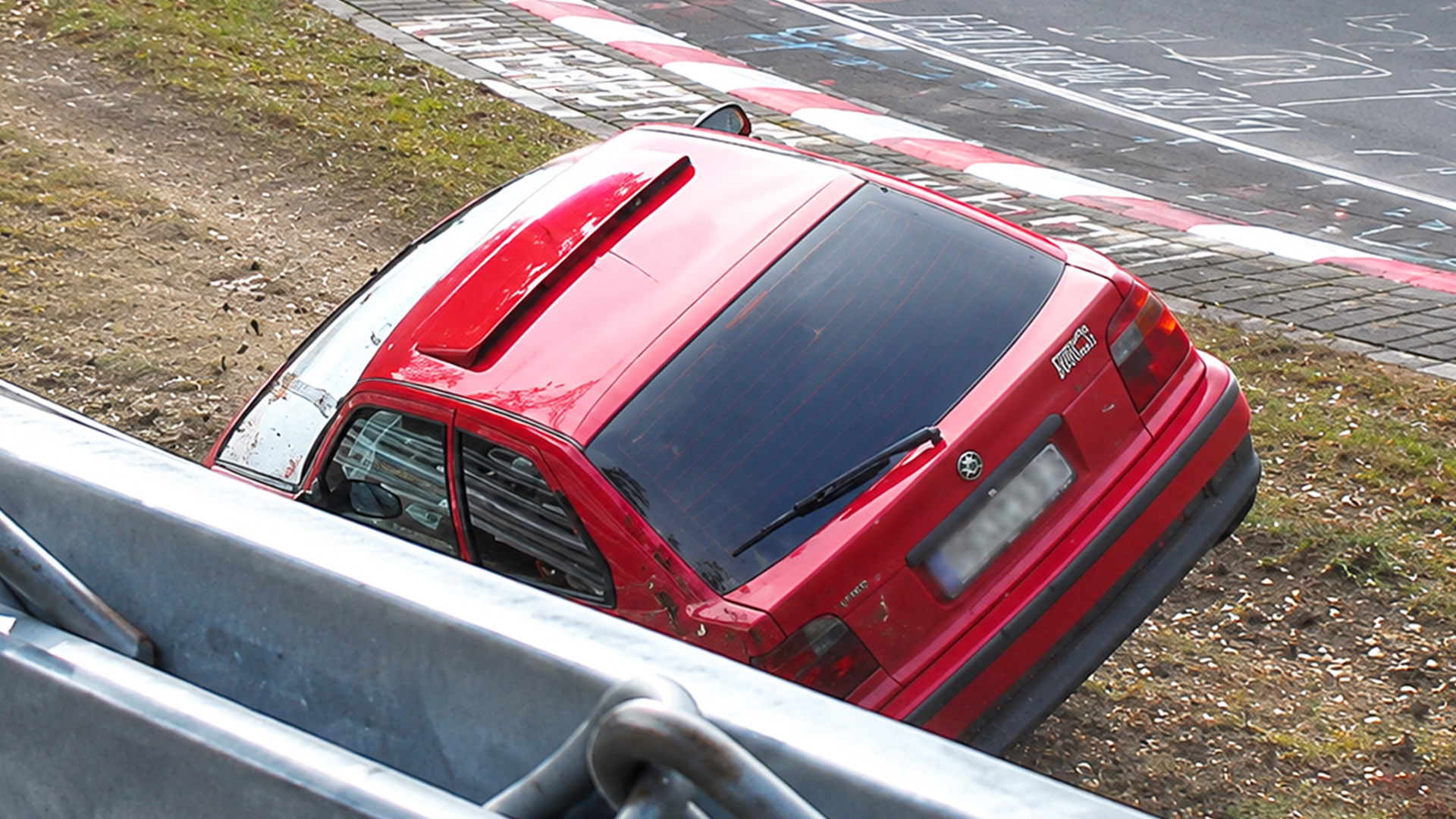 Loss of grip sends car into the dirt