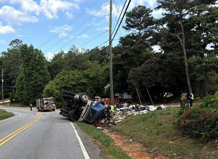 Road closed after garbage truck flips, spills trash across highway