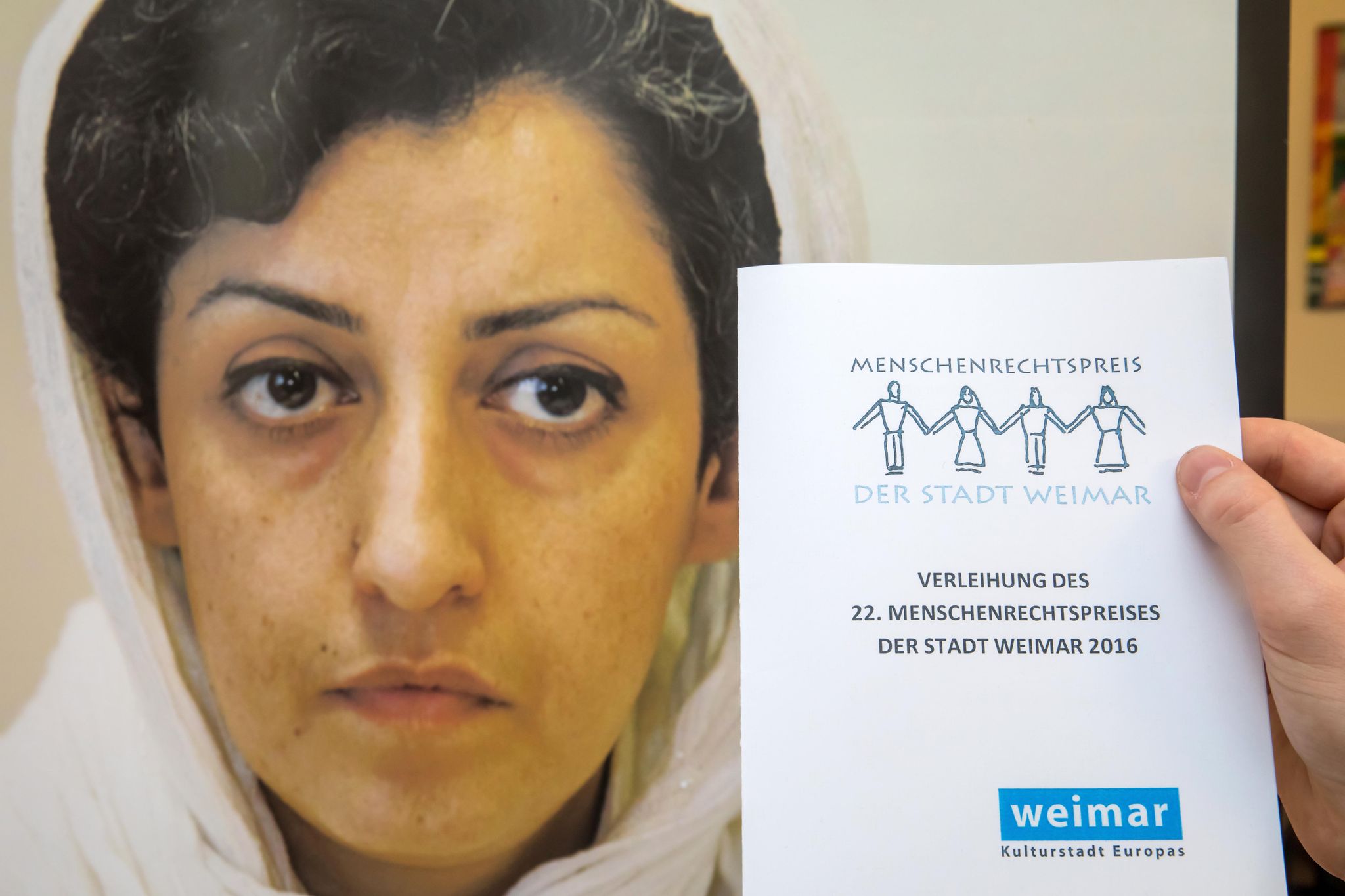 FILE PHOTO - A man holds the invitation to the event at a press conference during the award ceremony of the Weimar Human Rights Prize to Iranian activist Narges Mohammadi. (zu dpa: «Iranian Nobel laureate Mohammadi said to be deteriorating sharply») arifoto UG/dpa-Zentralbild/dpa