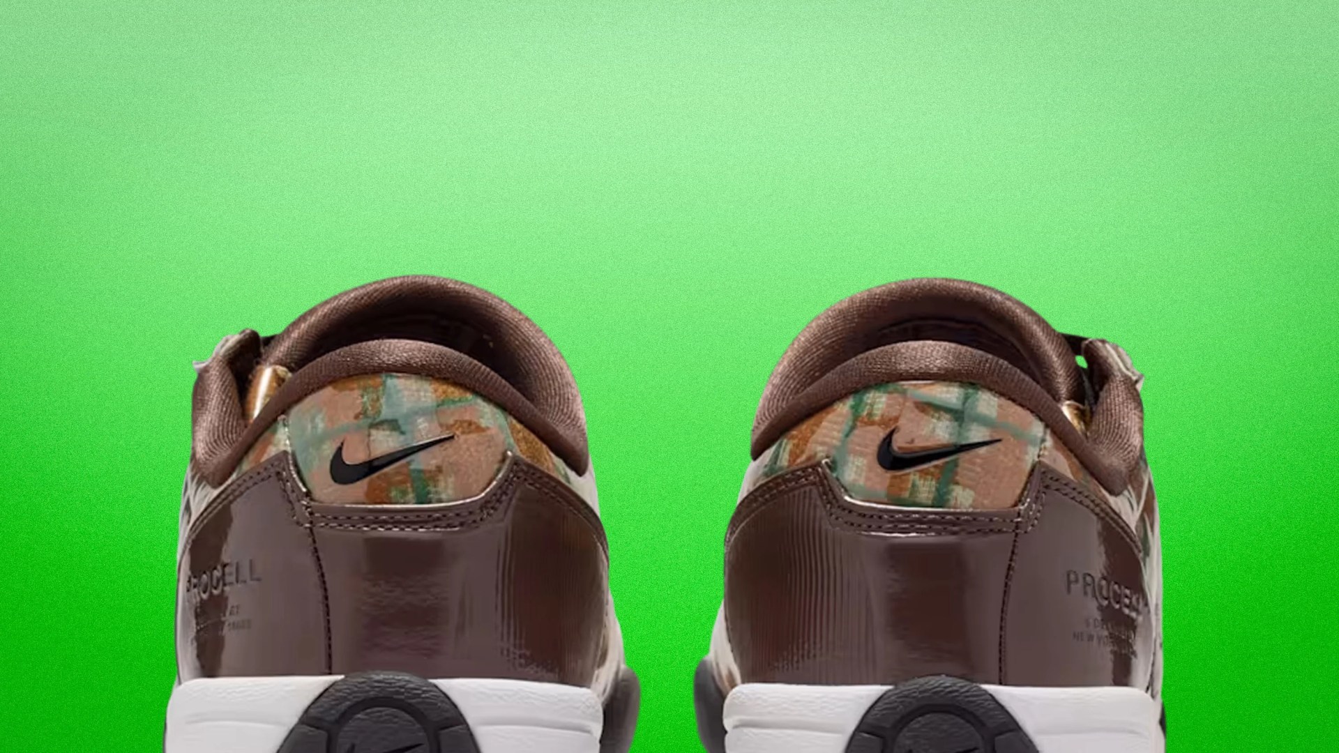 Pair of brown Nike sneakers with multicolor patterned heel and white soles against a green background.