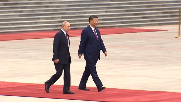 Putin spotted walking awkwardly as he arrives for summit in Beijing