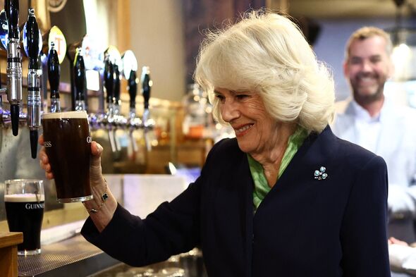Queen Camilla nervously pours pint of Guinness during Northern Ireland trip