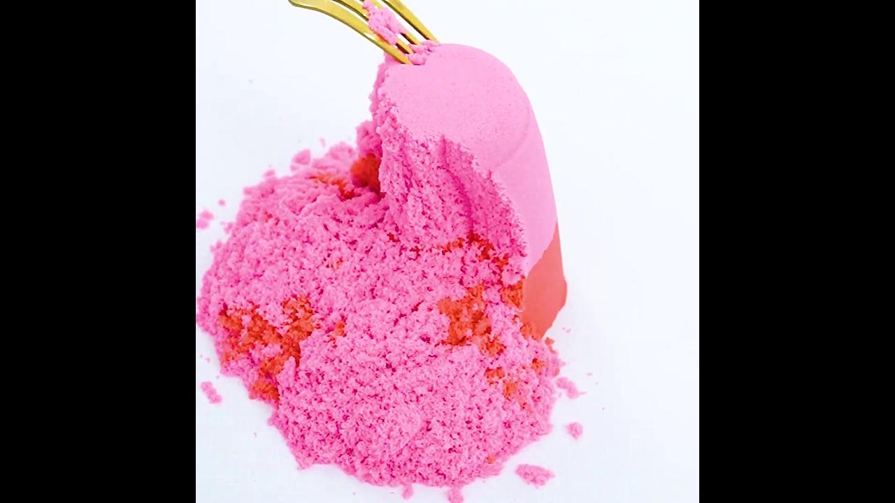 Satisfying fork scraping pink and coral sand tower creating soft ...