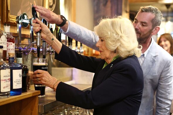 Queen Camilla nervously pours pint of Guinness during Northern Ireland trip
