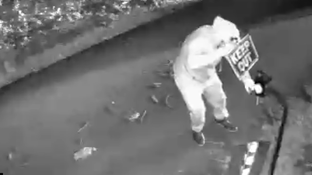 Security footage reveals masked intruder leaving chilling message on a ...