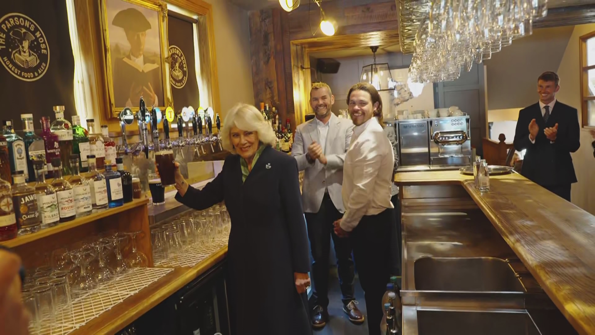 Queen says she's not quite the expert at pouring pints