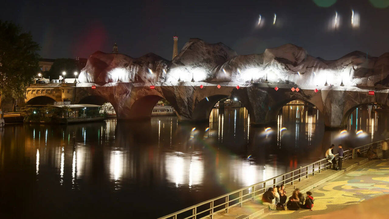 French artist JR inflates giant cave art over Paris' historic Pont Neuf