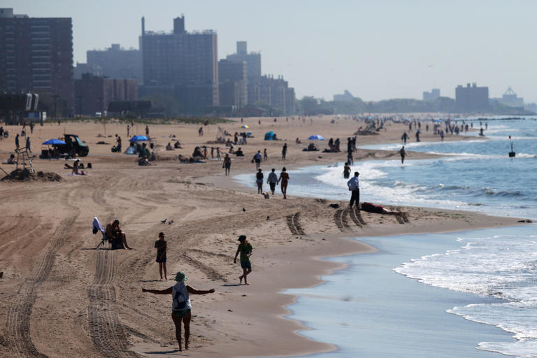 People gather on the beach at Coney Island in the Brooklyn borough of New York (Reuters)
