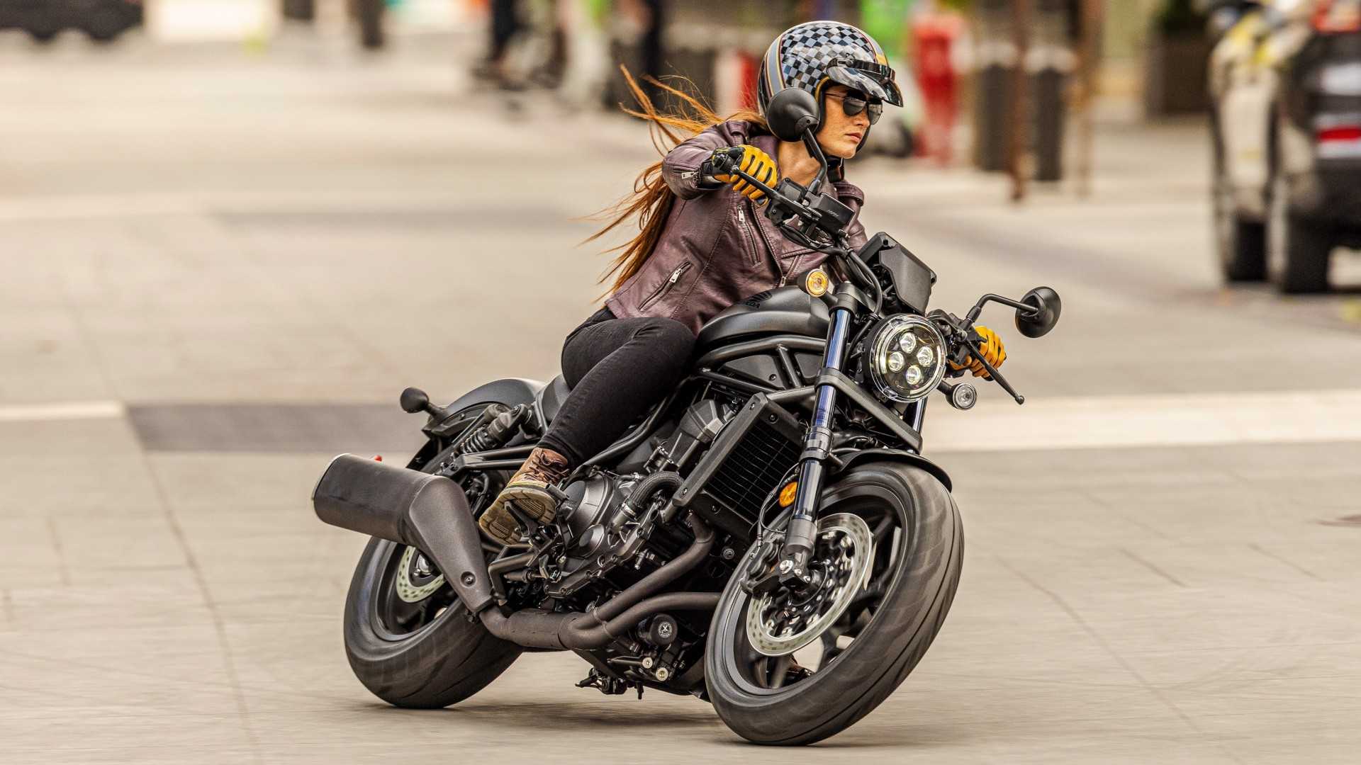 Honda Rebel 1100 cornering along an urban road front third quarter view