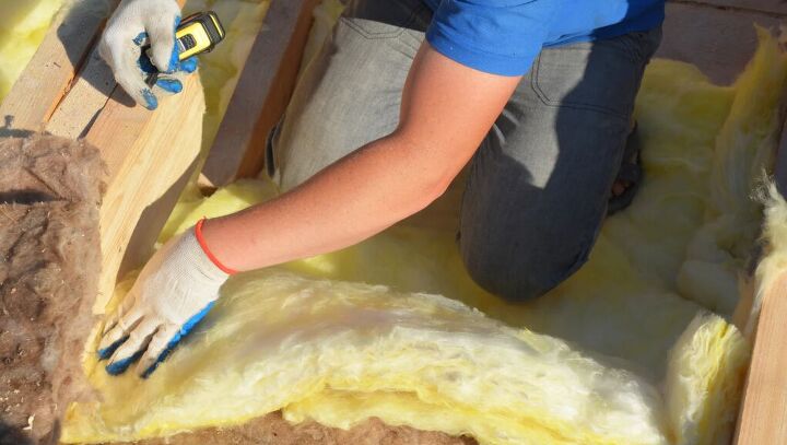 Installing attic insulation - image via Canva
