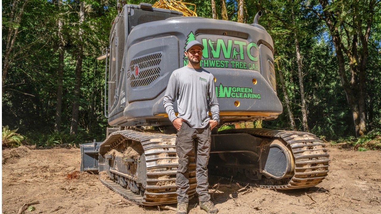 Compact excavator used for land clearing and tree care operations