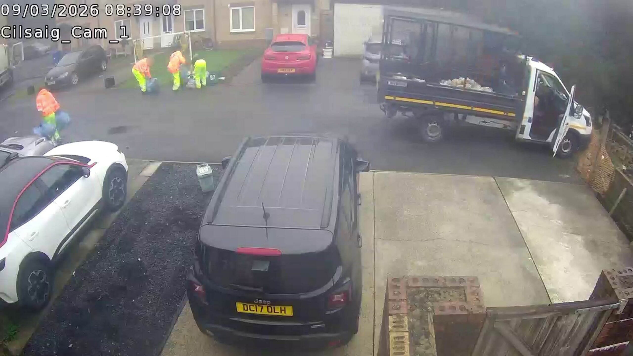 Runaway bin lorry crashes through fence and tumbles down bank