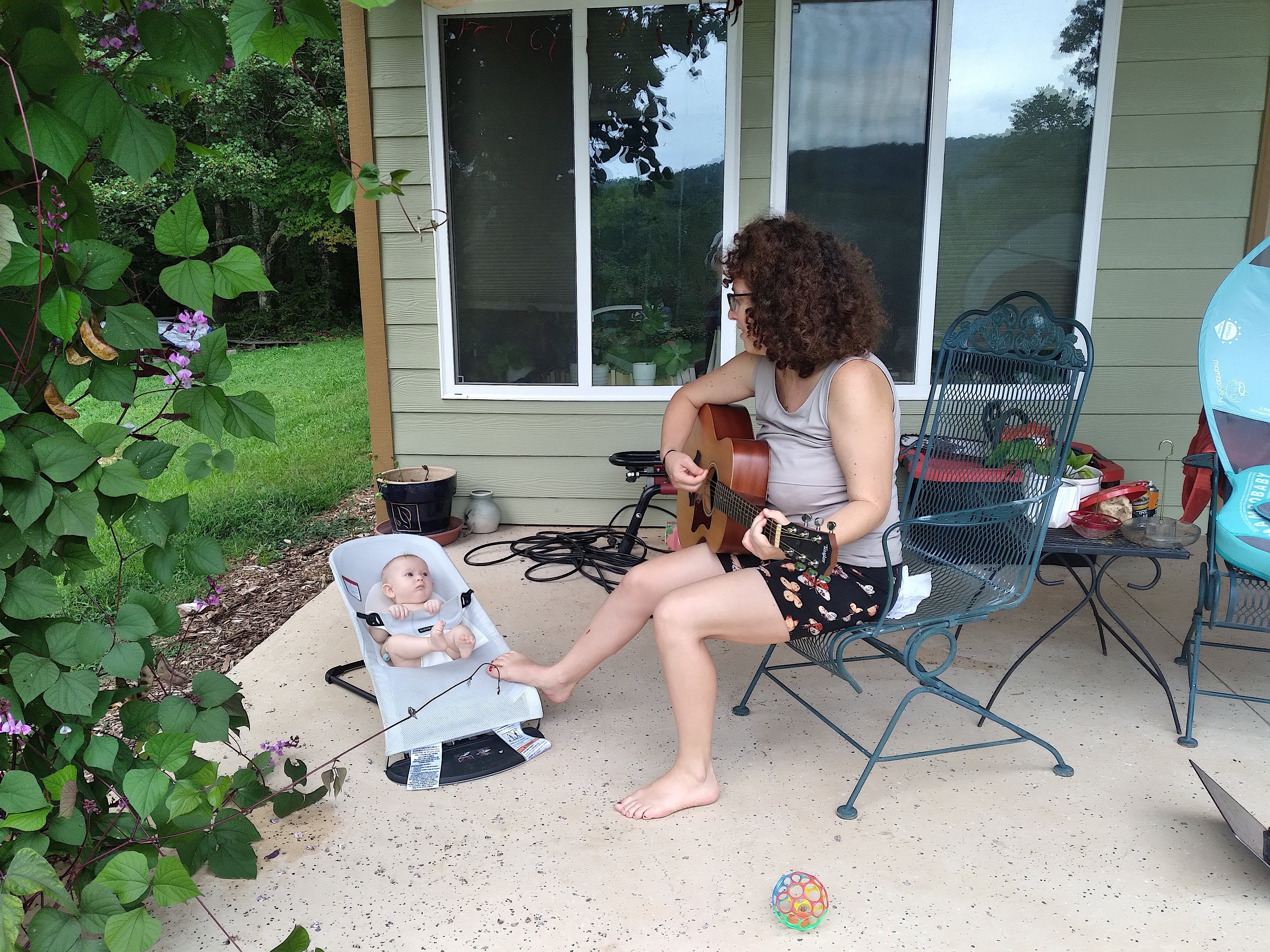 The author playing guitar for her daughter when she was a baby.