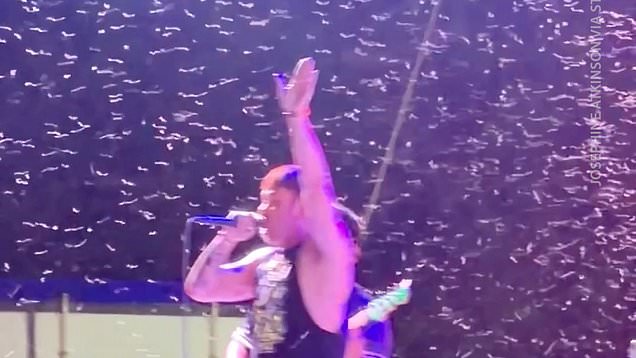 Singer gets swarmed by thousands of flying bugs during show