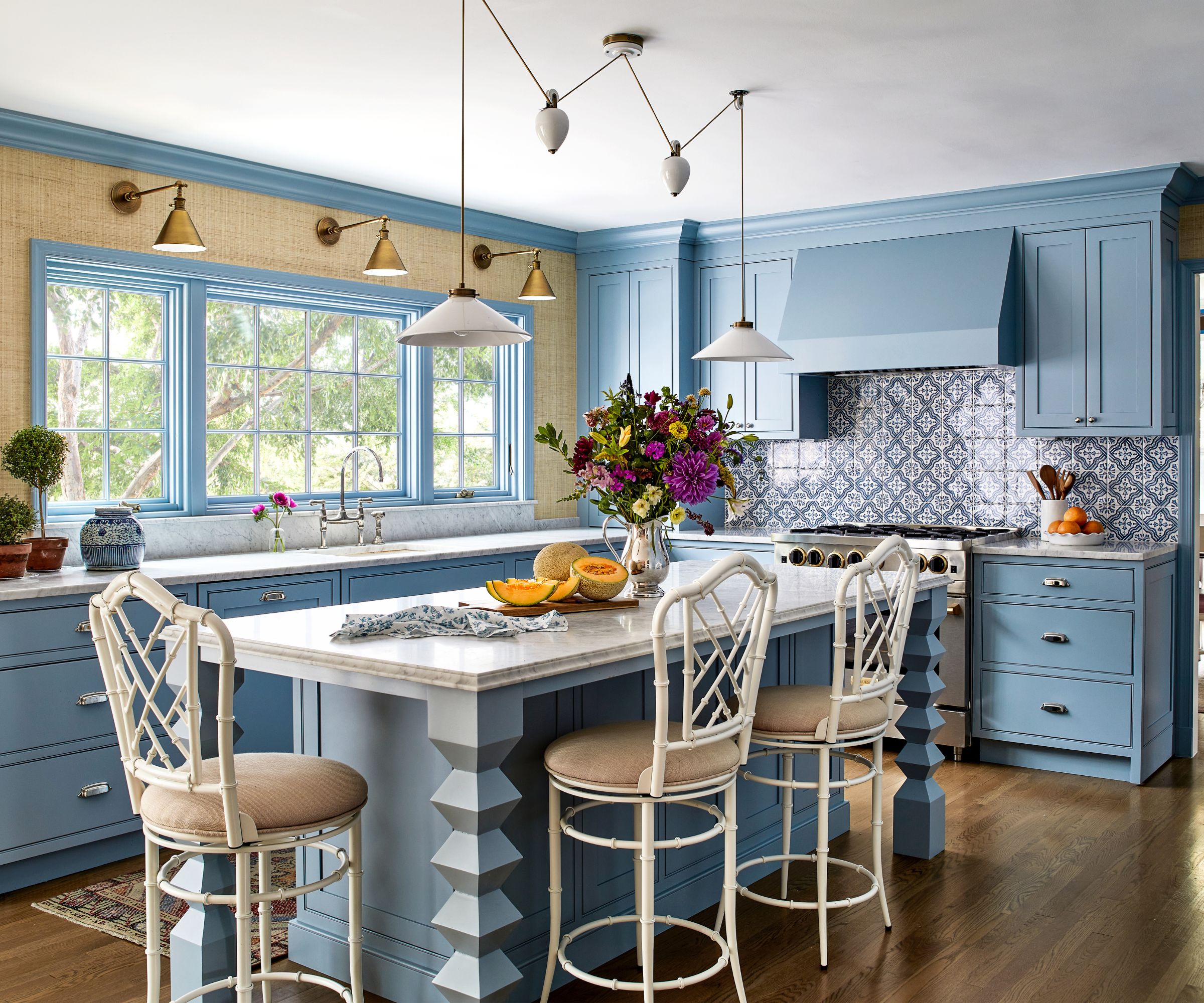 A blue kitchen with grasscloth wallpaper