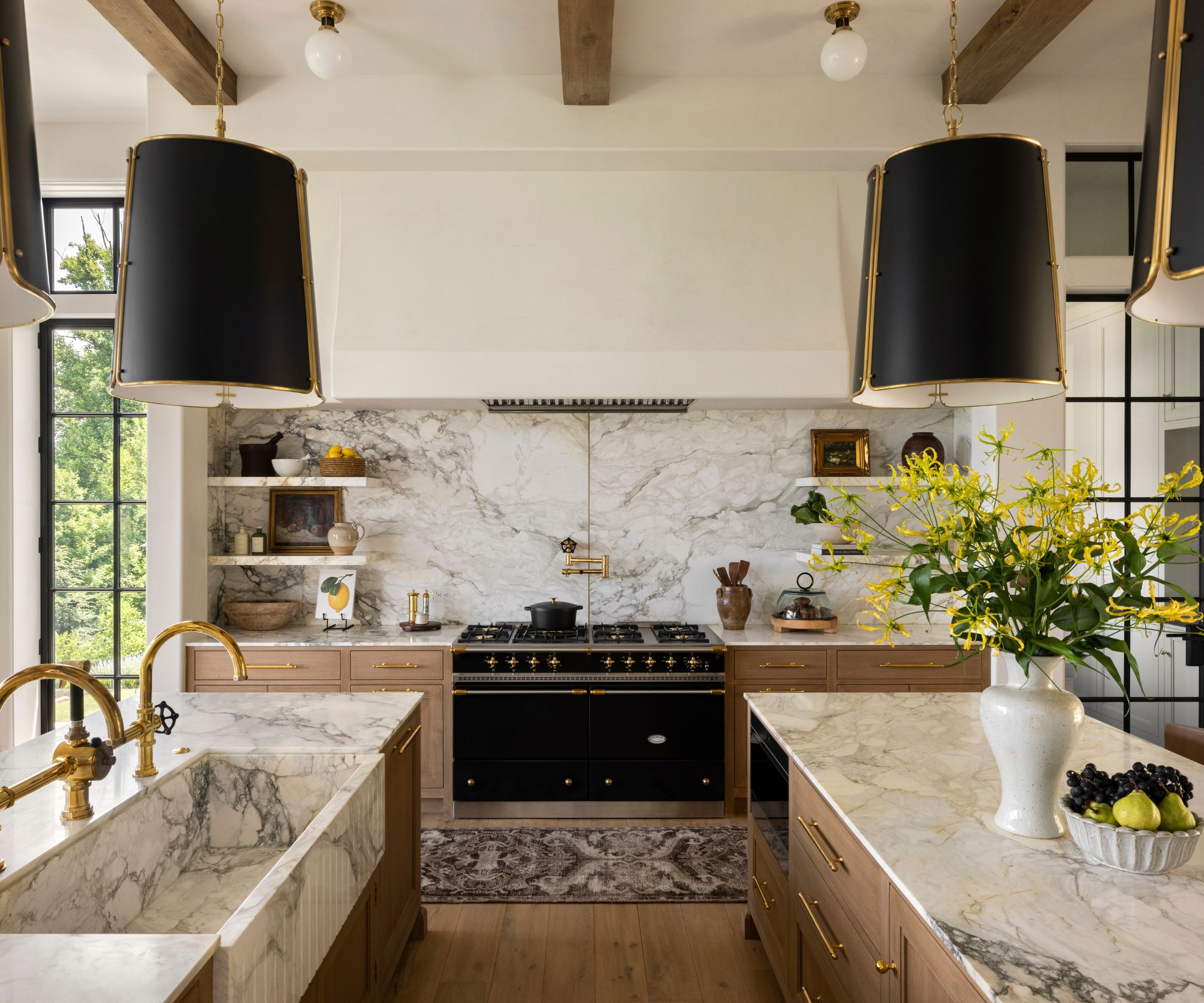 An open plan kitchen with a double island layout, wooden cabinets, and marble countertops