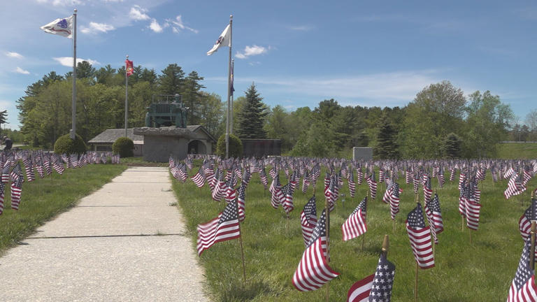 Volunteers place thousands of flags on museum grounds ahead of Memorial Day