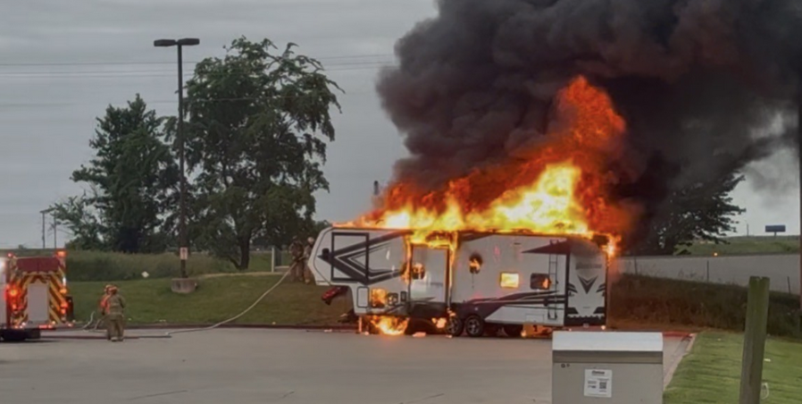 Firefighters battle camper fire
