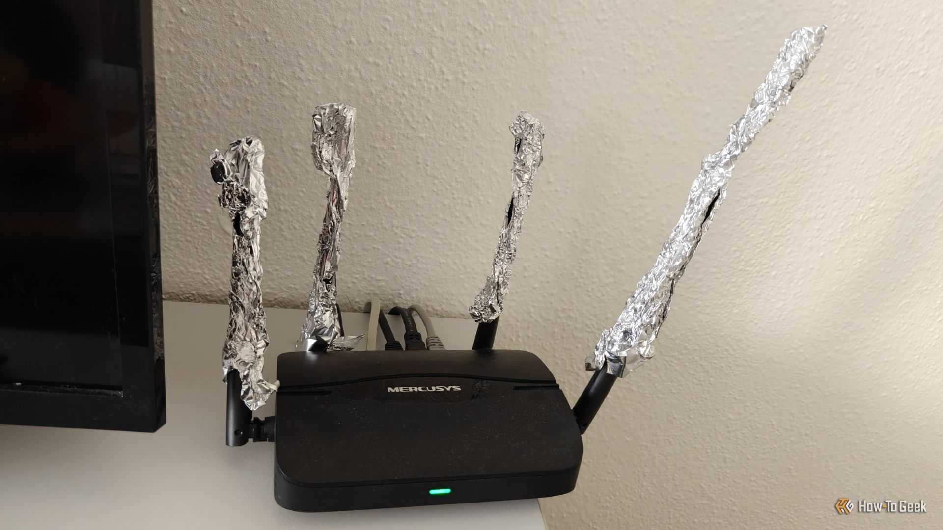A Wi-Fi router with the antennas extended using aluminum foil.