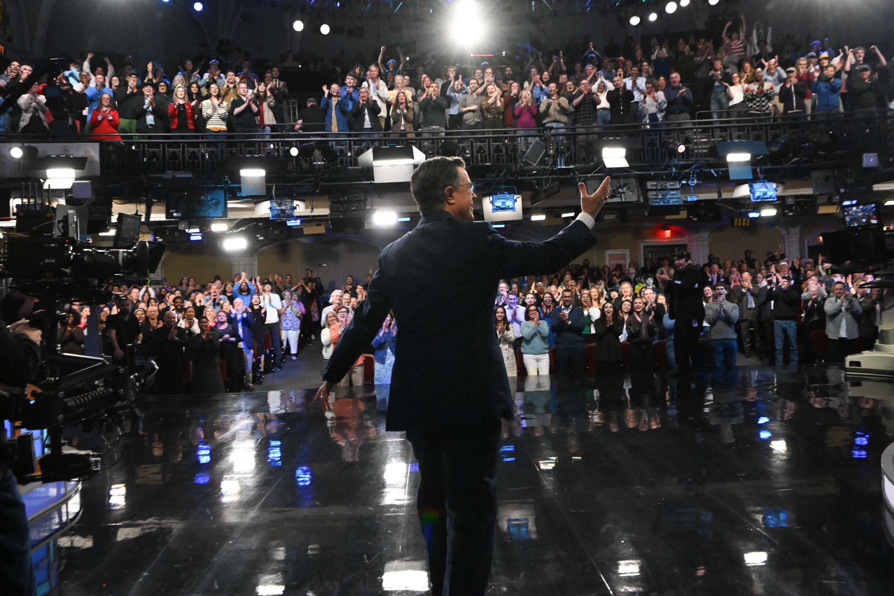 Late-night TV fans are bidding farewell to Stephen Colbert and "The Late Show." After CBS canceled the late-night show, "The Late Show" aired its final episode May 21, 2026. Get an inside look at the emotional photos from Colbert's last show. Here, Colbert waves to the applauding crowd in the studio during the May 21 finale.