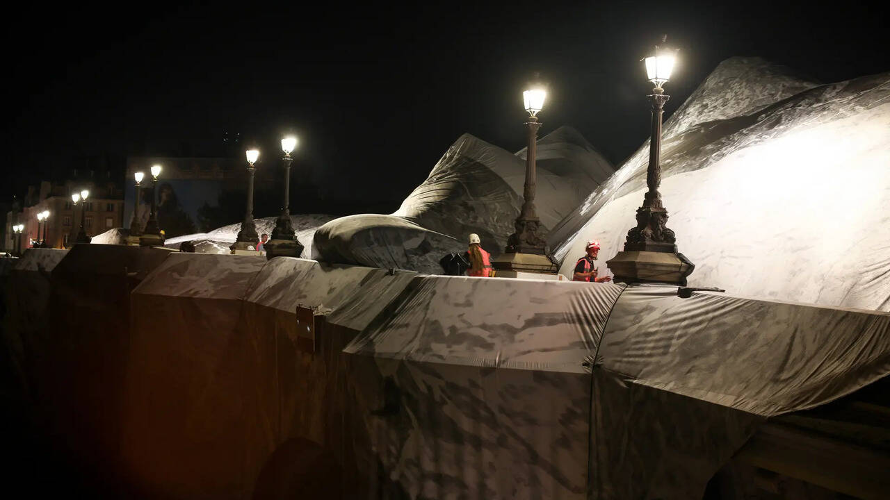 JR inflates monumental 'cave' art over Paris' Pont Neuf