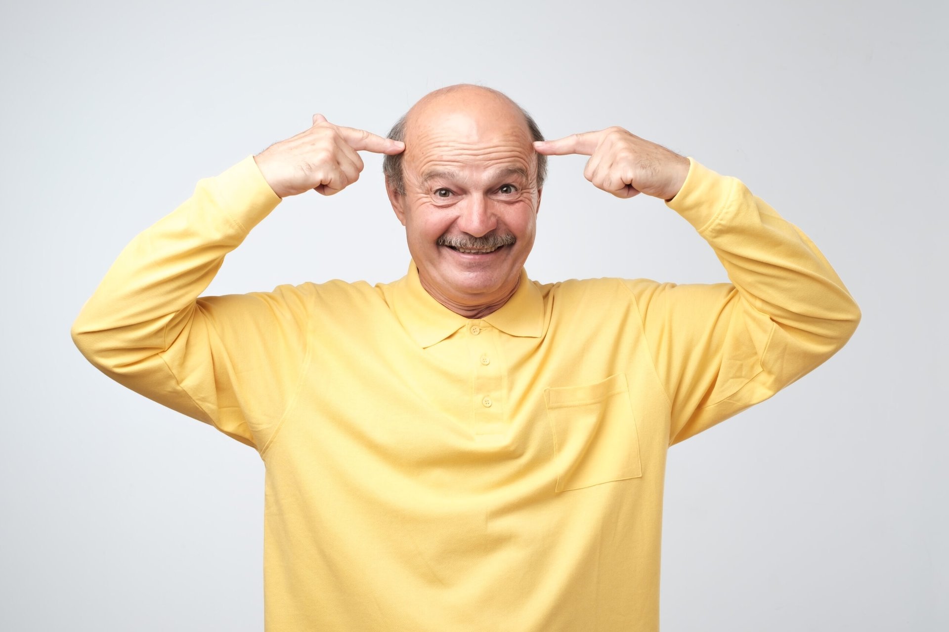 Senior man pointing to his brain
